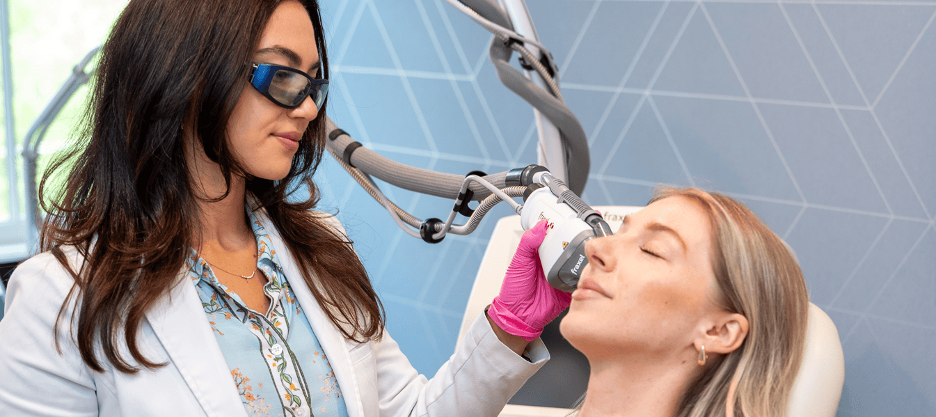 NicholsMD clinician performing a Fraxel laser treatment on a patient's face